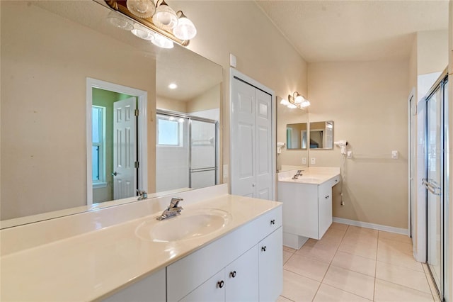404 Hightower Dr, Debary, FL 32713 - full bathroom with a stall shower, two vanities, tile patterned flooring, and baseboards