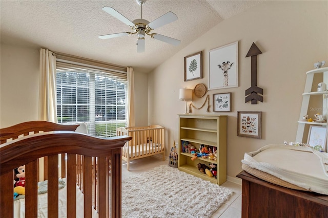 404 Hightower Dr, Debary, FL 32713 - bedroom featuring lofted ceiling, light tile patterned floors, a textured ceiling, a ceiling fan, and a nursery area