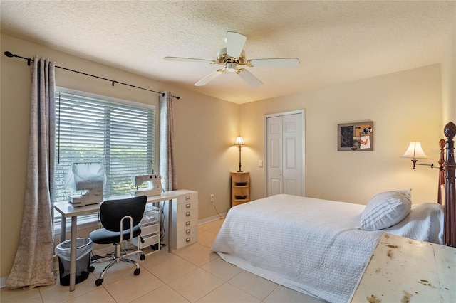 404 Hightower Dr, Debary, FL 32713 - bedroom with a textured ceiling, light tile patterned floors, ceiling fan, a desk, and a closet