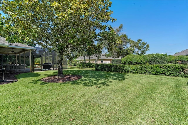 404 Hightower Dr, Debary, FL 32713 - view of green lawn with glass enclosure and a patio area