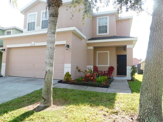 view of front of property featuring a garage and a front yard