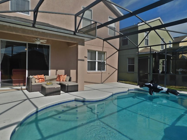 view of swimming pool with an outdoor living space, a patio, ceiling fan, and glass enclosure