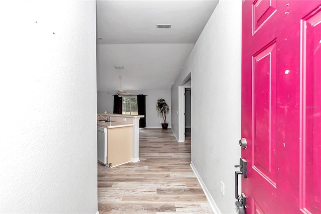 interior space with light hardwood / wood-style floors and sink