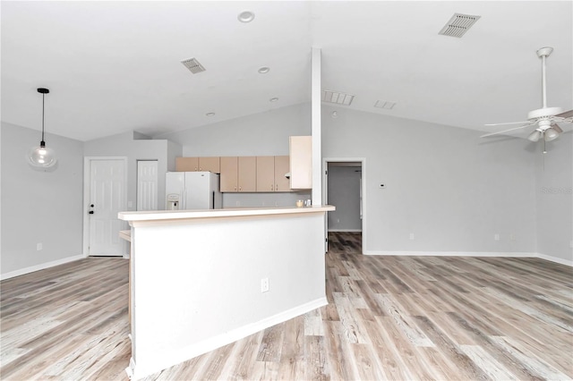 kitchen featuring white fridge with ice dispenser, ceiling fan, light hardwood / wood-style floors, light brown cabinetry, and high vaulted ceiling