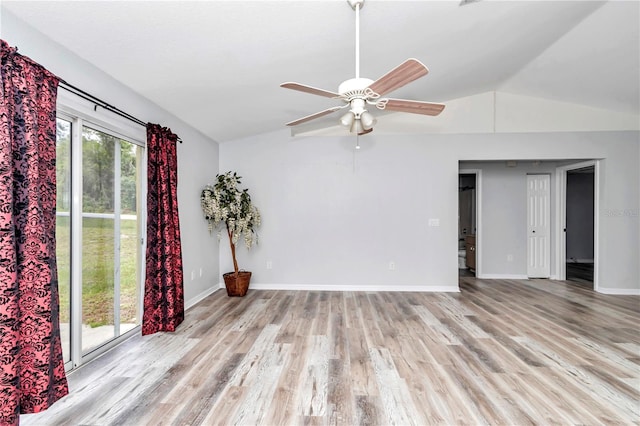 spare room featuring light hardwood / wood-style floors, vaulted ceiling, and ceiling fan