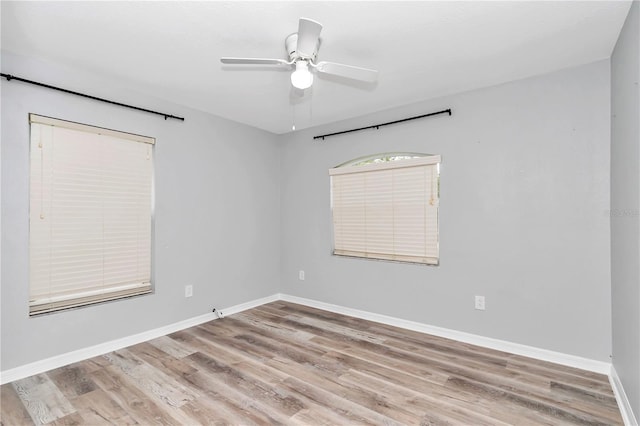 empty room featuring wood-type flooring and ceiling fan