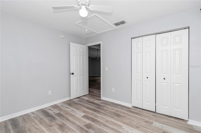 unfurnished bedroom with light hardwood / wood-style flooring, ceiling fan, and a closet