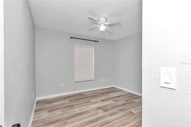 empty room with light wood-type flooring and ceiling fan