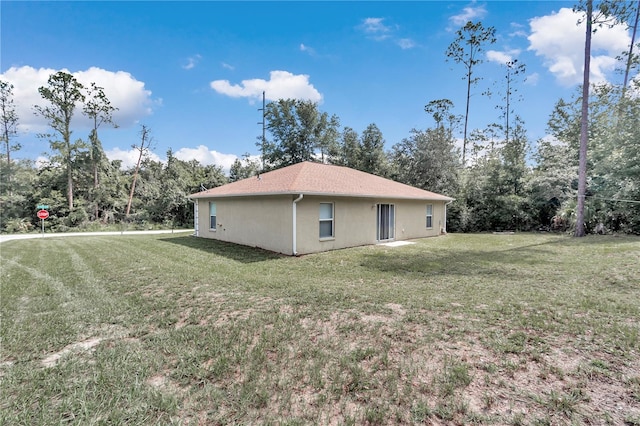 view of side of property with a lawn