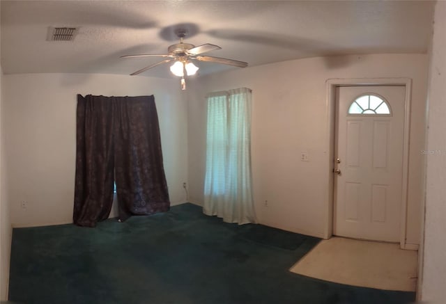 foyer entrance featuring carpet flooring and ceiling fan