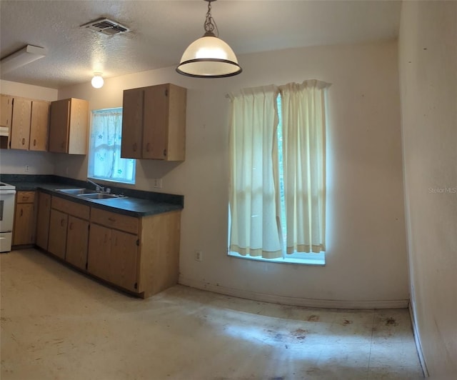 kitchen with white stove, sink, decorative light fixtures, a textured ceiling, and light tile patterned flooring