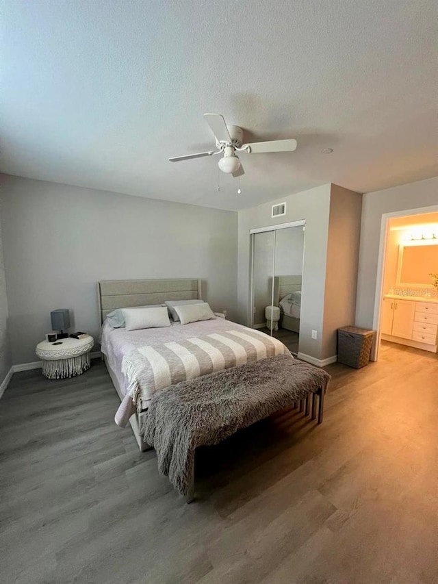 bedroom featuring a closet, a textured ceiling, hardwood / wood-style floors, and ceiling fan