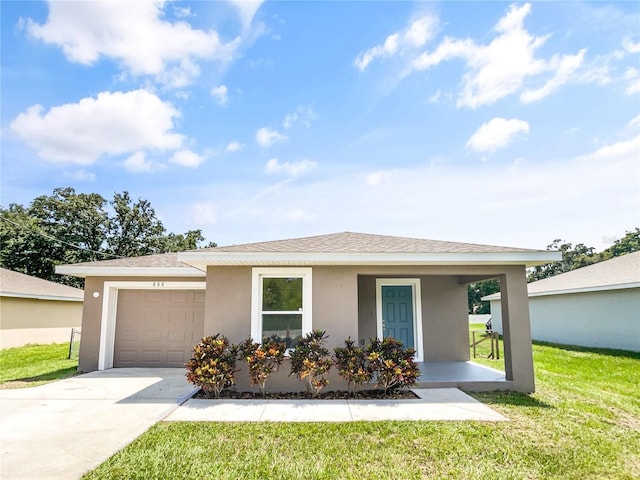 view of front facade with a garage, a front lawn, and covered porch