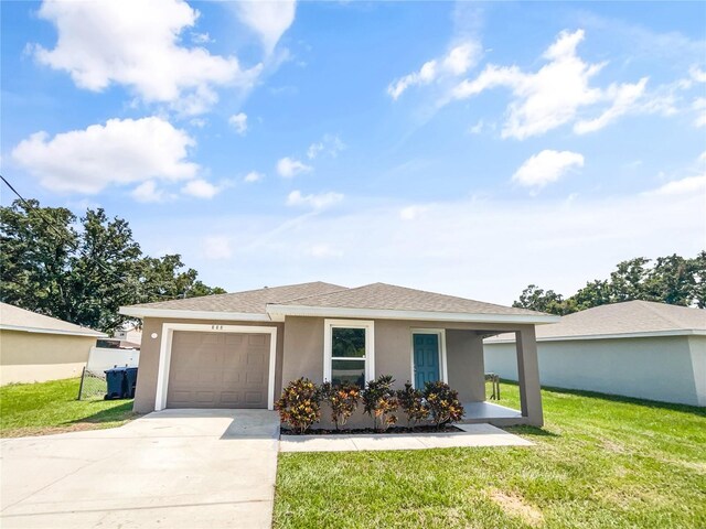 view of front facade with a garage and a front lawn