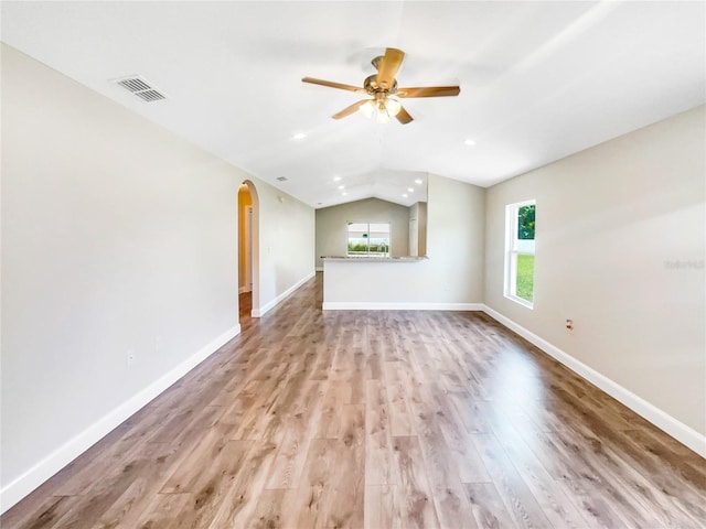 unfurnished living room featuring vaulted ceiling, ceiling fan, and light hardwood / wood-style floors