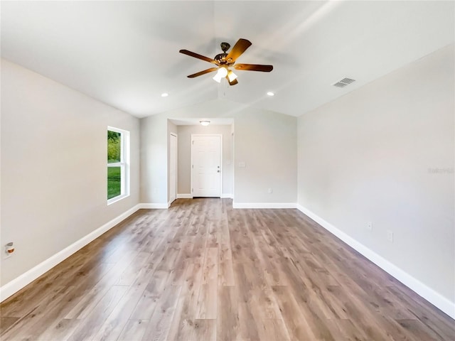 empty room featuring ceiling fan, lofted ceiling, and light hardwood / wood-style floors