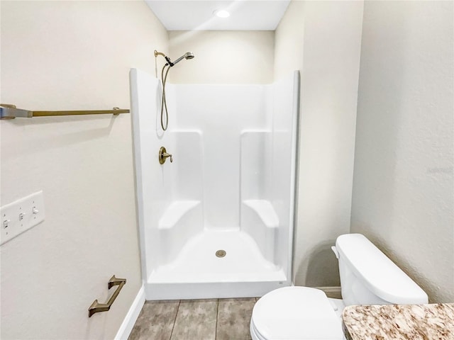 bathroom with walk in shower and toilet