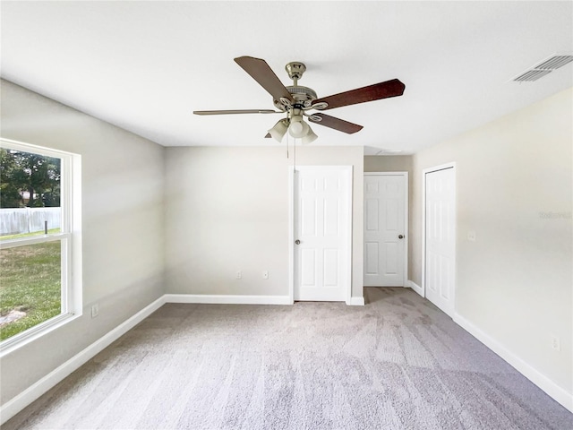 spare room with light carpet and ceiling fan