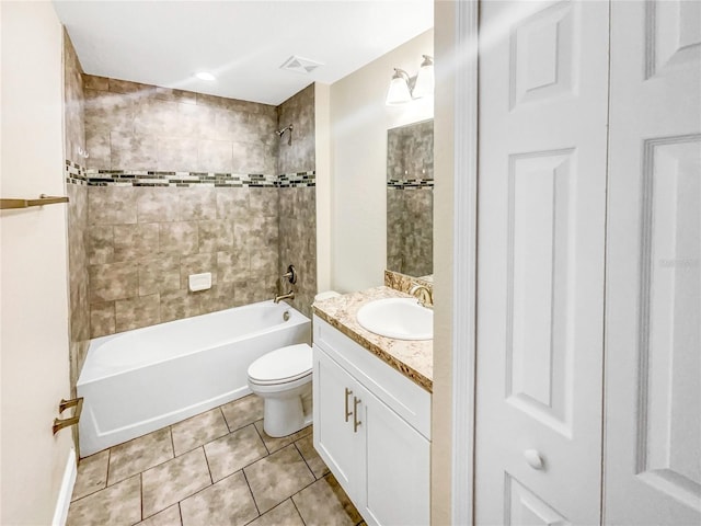 full bathroom with vanity, tiled shower / bath, tile patterned floors, and toilet