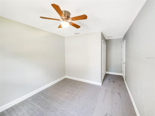 unfurnished room featuring light colored carpet and ceiling fan