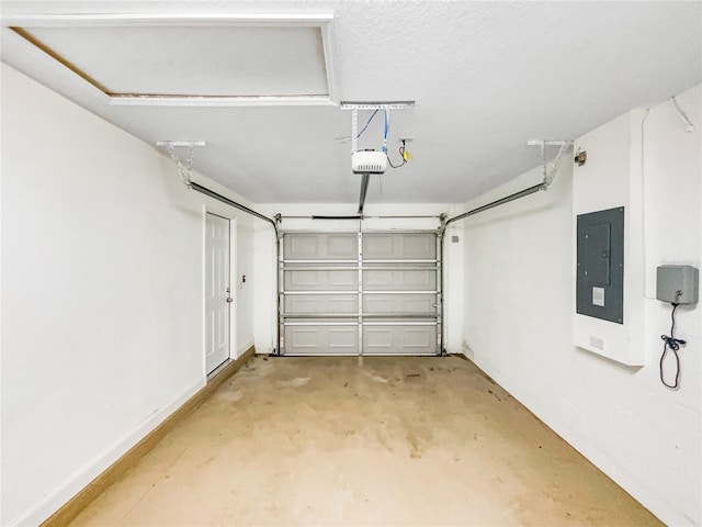 garage with a garage door opener and electric panel