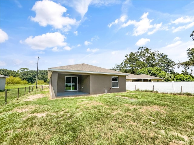 rear view of house with a yard