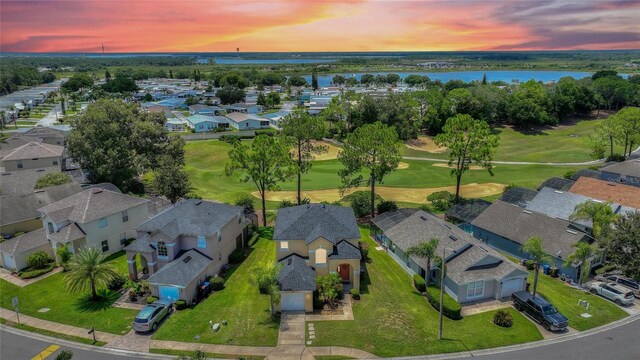 aerial view at dusk with a water view