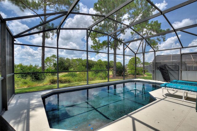 view of swimming pool with a patio and a lanai