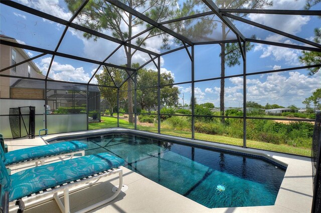 view of pool with a lanai and a patio