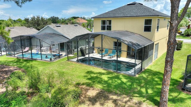 back of property with a lanai, a patio area, and a lawn