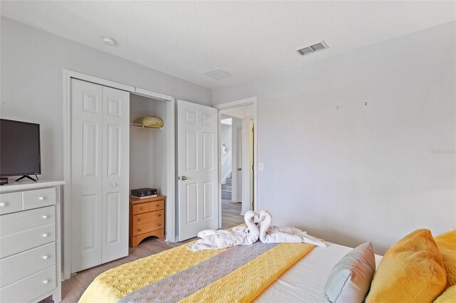 bedroom featuring a closet and hardwood / wood-style floors