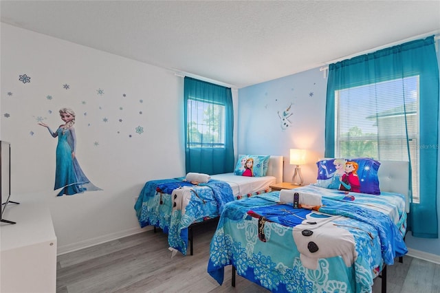 bedroom featuring a textured ceiling and hardwood / wood-style floors