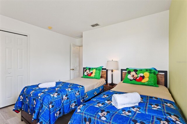 bedroom featuring hardwood / wood-style flooring and a closet