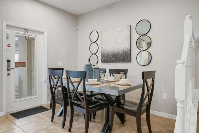 dining room with light tile patterned flooring and baseboards