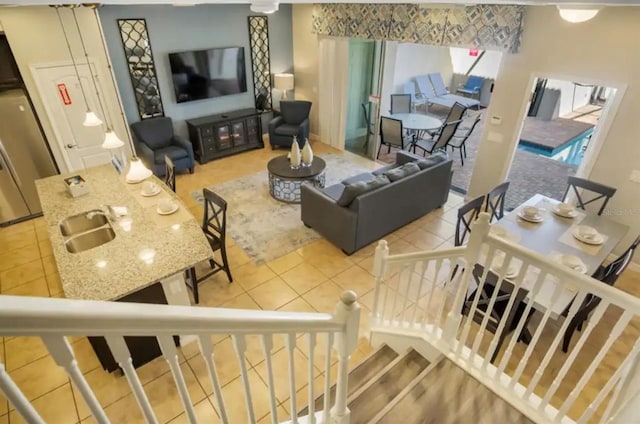 tiled living room featuring stairway and a sink