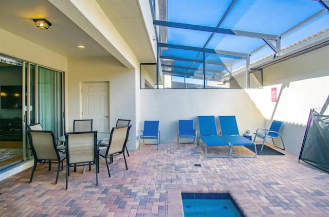 view of patio / terrace featuring glass enclosure