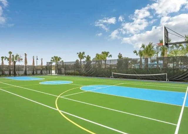 view of basketball court with a tennis court, community basketball court, and fence