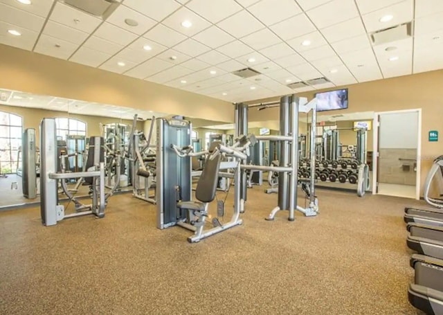 workout area with a paneled ceiling and recessed lighting