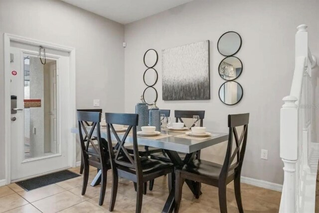dining area featuring light tile patterned floors and baseboards