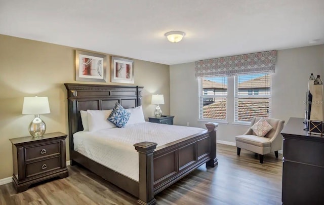 bedroom with wood finished floors and baseboards