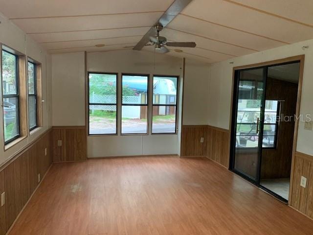 unfurnished room with hardwood / wood-style floors, ceiling fan, and a healthy amount of sunlight