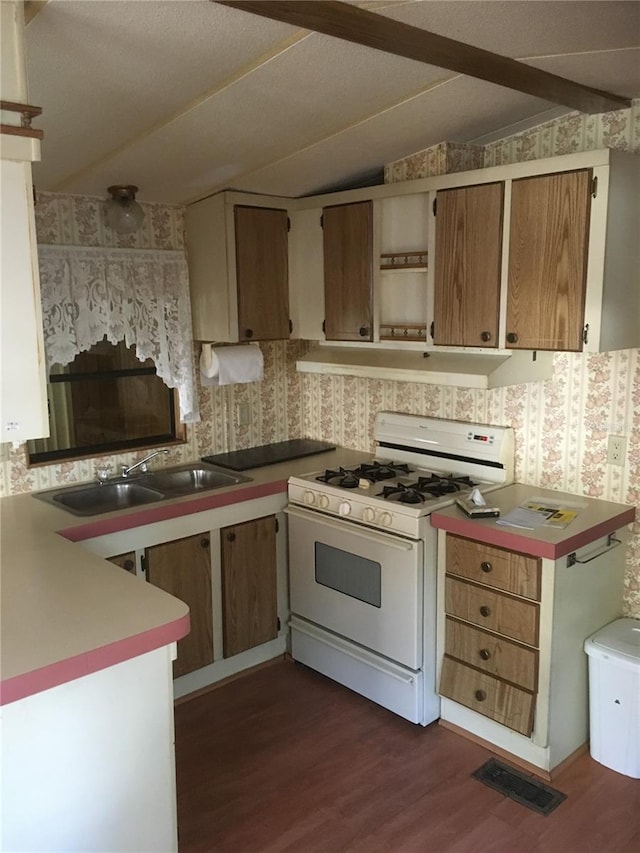 kitchen featuring sink, dark wood-type flooring, white gas range, and lofted ceiling