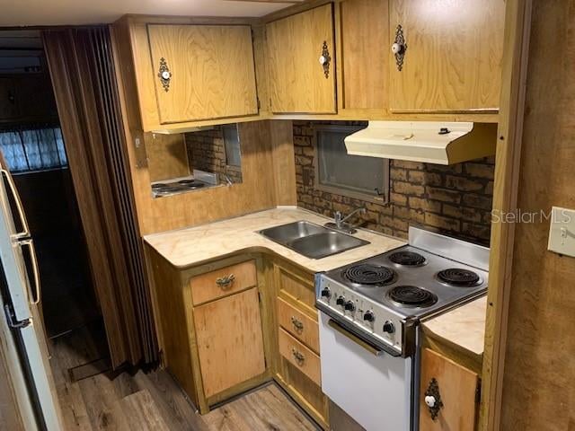 kitchen featuring sink, white electric stove, light hardwood / wood-style flooring, and premium range hood