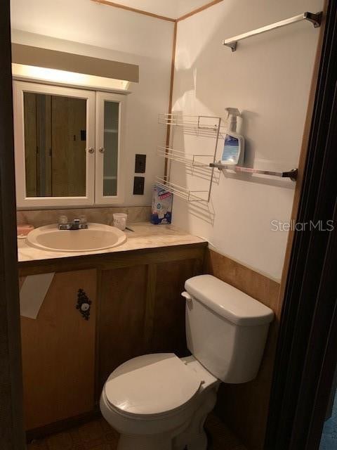 bathroom featuring vanity and toilet