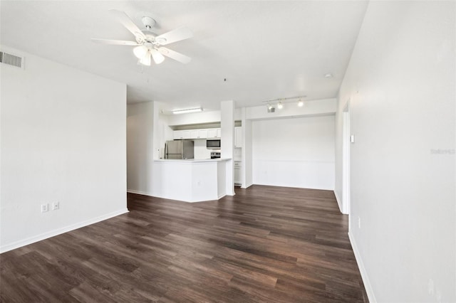 unfurnished living room with ceiling fan, dark hardwood / wood-style flooring, and track lighting