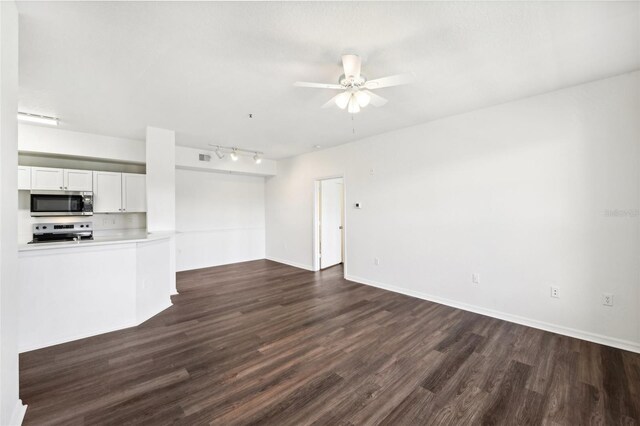 unfurnished living room featuring ceiling fan, hardwood / wood-style floors, and track lighting