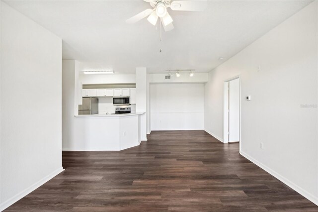 unfurnished living room with track lighting, wood-type flooring, and ceiling fan