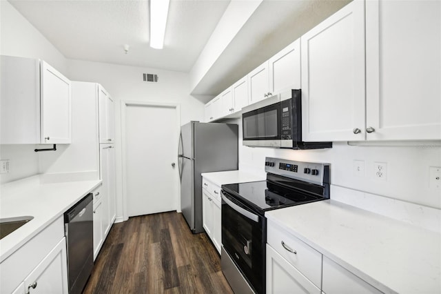 kitchen featuring white cabinets, stainless steel appliances, and dark hardwood / wood-style flooring