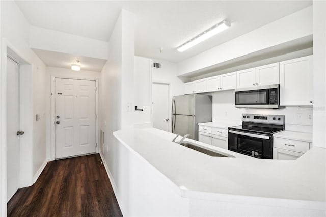 kitchen with stainless steel appliances, dark hardwood / wood-style flooring, sink, and kitchen peninsula