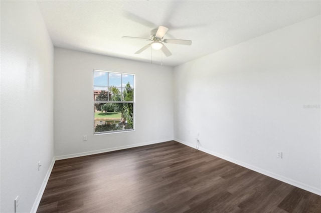 spare room with dark hardwood / wood-style flooring and ceiling fan